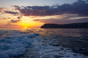 Obraz premium Raging sea waves at sunset in the ocean. Storm clouds on the sea.