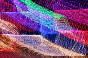 Vibrant and colorful LED lights create abstract light trails when an in camera photo technique is used while taking the photo.