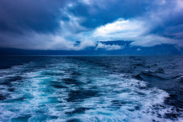 Storm clouds and raging waves in the sea in the evening during a storm in winter.