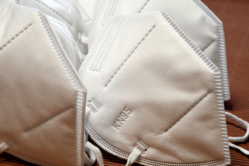 detail of a ffp2 protective masks on a brown background. Covid19 or Coronavirus prevention.