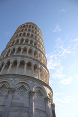 Tower of Pisa stands out against a blue sky