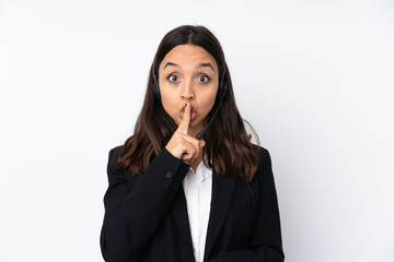 Young telemarketer woman isolated on white background showing a sign of silence gesture putting finger in mouth