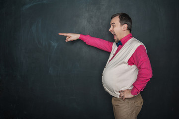 Angry screaming thick teacher pointing out on blackboard background