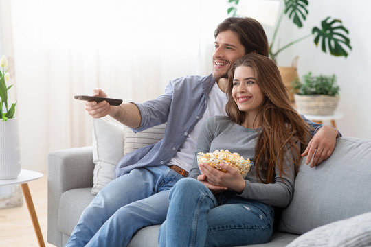 Happy Couple Watching Movie At Home, Eating Popcorn