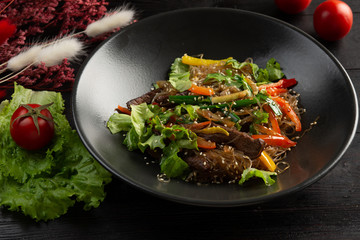 funchose noodles with veal on a dark wooden background