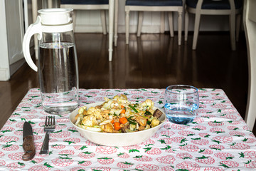 stir fry salad, asian style cooked. Salad with cauliflower, chicken, onion, broccoli and lettuce served on a plate