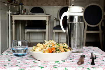 stir fry salad, asian style cooked. Salad with cauliflower, chicken, onion, broccoli and lettuce served on a plate