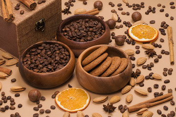 Gift set of coffee beans, oatmeal cookies, cinnamon, almond, macadamia on background