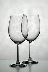 Two glasses for wine on a light background