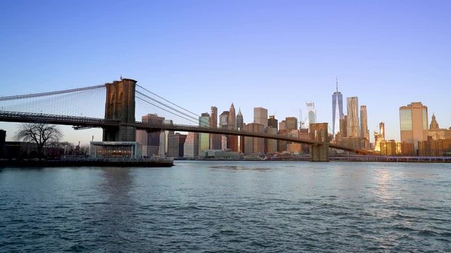 Famous Skyline of downtown New York, Brooklyn Bridge and Manhattan at the early morning sun light , New York City USA .