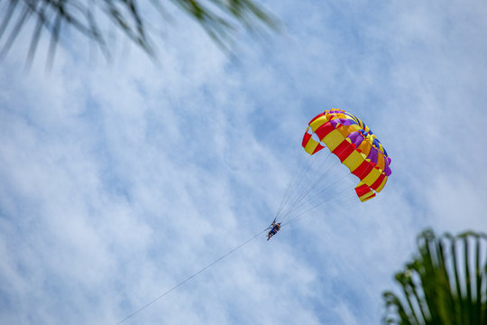 Parasailing man on the sky background
