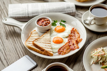 Breakfast with coffee toast with egg juice daylight cafe restaurant towel american wooden table