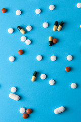 Mixture of multiple types of drugs randomly spread on a blue background