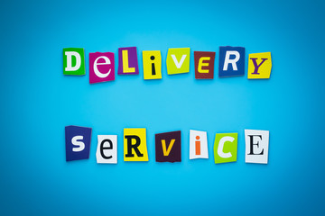 Obraz premium A word writing text - delivery service. Cartoon colorful letters on a blue background. Headline, banner with inscription font.