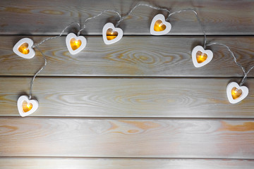 hearts garland on a wooden background top view