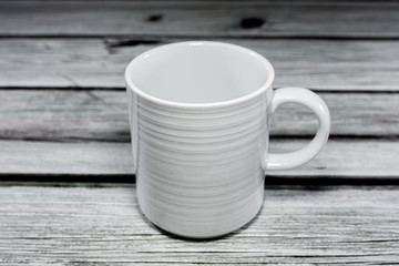 An empty coffee mug on a wooden background