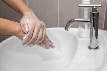 Coronavirus pandemic prevention by  wash hands and fingers with soap for frequently, using hand sanitizer gel.