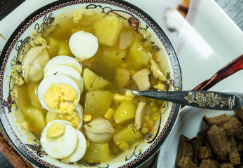 The sour soup made of rye flour with eggs on dish
