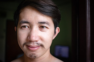 Close up shot of Asian man face with long beard and mustache