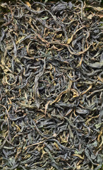 Handmade green or black tea made of fermented blooming sally herb, background texture, flat lay, overhead top view from above, closeup