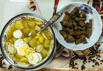 The sour soup made of rye flour with eggs on dish