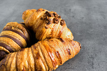 Photograph of three different kinds of traditional croissants recently baked, a delicious snack.