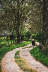 a woman on the dirt road