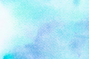 Abstract blue watercolor on white background.The color splashing in the paper.It is a hand drawn.