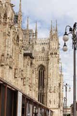 Fototapeta na wymiar Fragment of the decorated side outer wall and the roof of the Cathedral of Milan - Duomo di Milano in Milan, Italy
