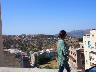 A woman walks outside the old town, Medina, Chaouen (Chefchaouen), Morocc