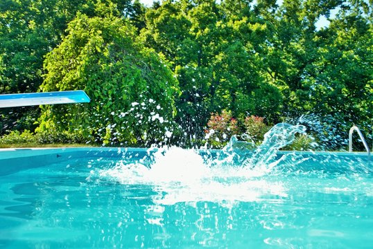 Splash After Someone Jumped Into A Swimming Pool From The Diving Board