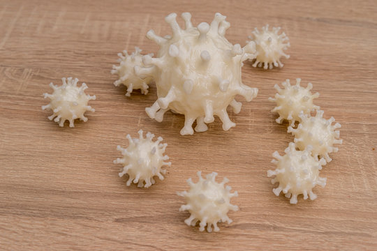 covid19, 3d printed representation of the virus on a wooden surface. home security and protection against viruses