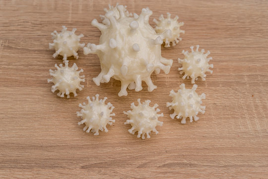 covid19, 3d printed representation of the virus on a wooden surface. home security and protection against viruses