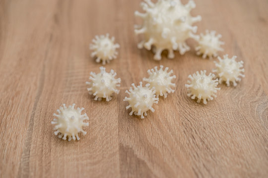 covid19, 3d printed representation of the virus on a wooden surface. home security and protection against viruses