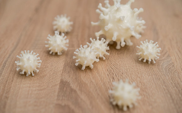 covid19, 3d printed representation of the virus on a wooden surface. home security and protection against viruses