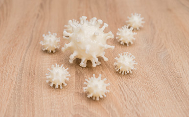 covid19, 3d printed representation of the virus on a wooden surface. home security and protection against viruses