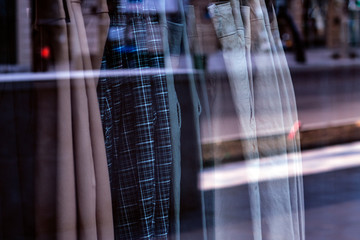 Clothes on hangers close up in shopfront. Street view shopfront. 