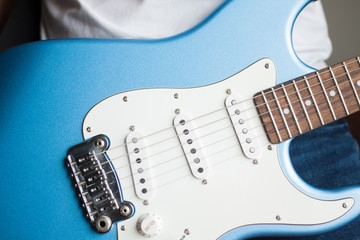 Close-up of blue and white electric guitar