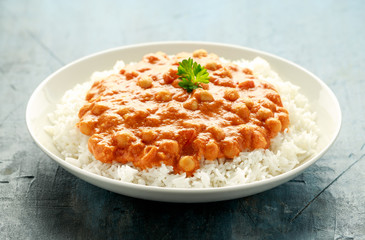 Spicy chickpeas curry with rice, tomato and Poppadoms in white plate. Healthy tasty vegetarian food