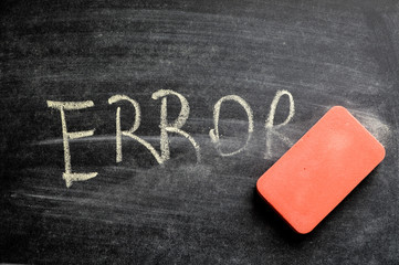 erasing error, hand written word on blackboard being erased concept