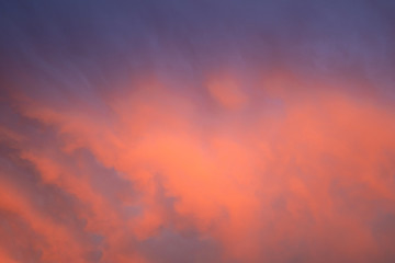 Soft and Vibrant bright orange purple and blue sky full of clouds at sunset to be used as a background with copy space