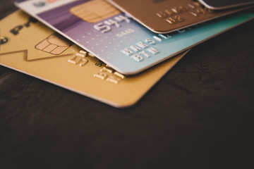 Macro shot of colorful credit cards on brown leather background