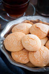 Homemade sugar cookies with craquelure crust in a metal vase, selective focus