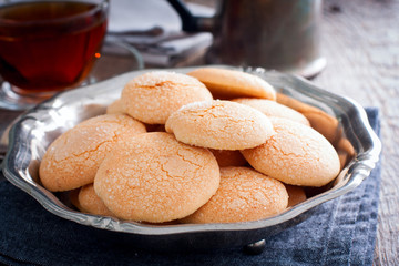Homemade sugar cookies with craquelure crust in a metal vase, selective focus