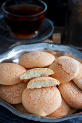 Homemade sugar cookies with craquelure crust in a metal vase, selective focus