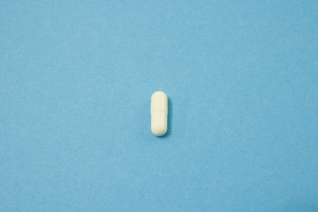 White capsule on blue background