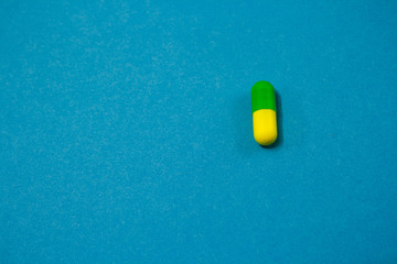 Colorful capsule on blue background