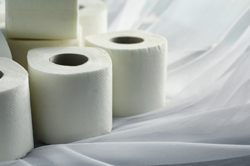 Toilet paper in a roll. Snow-white soft three-layer toilet paper. Lack of hygiene products. Primary protection and disinfection.