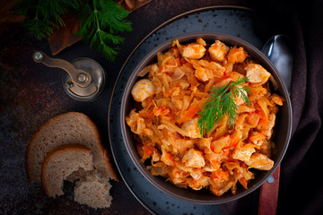 Braised cabbage with chicken breast fillet, top view, selective focus