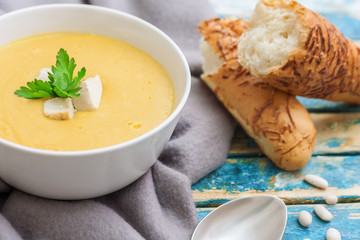 healthy soup at plate on a blue wooden table